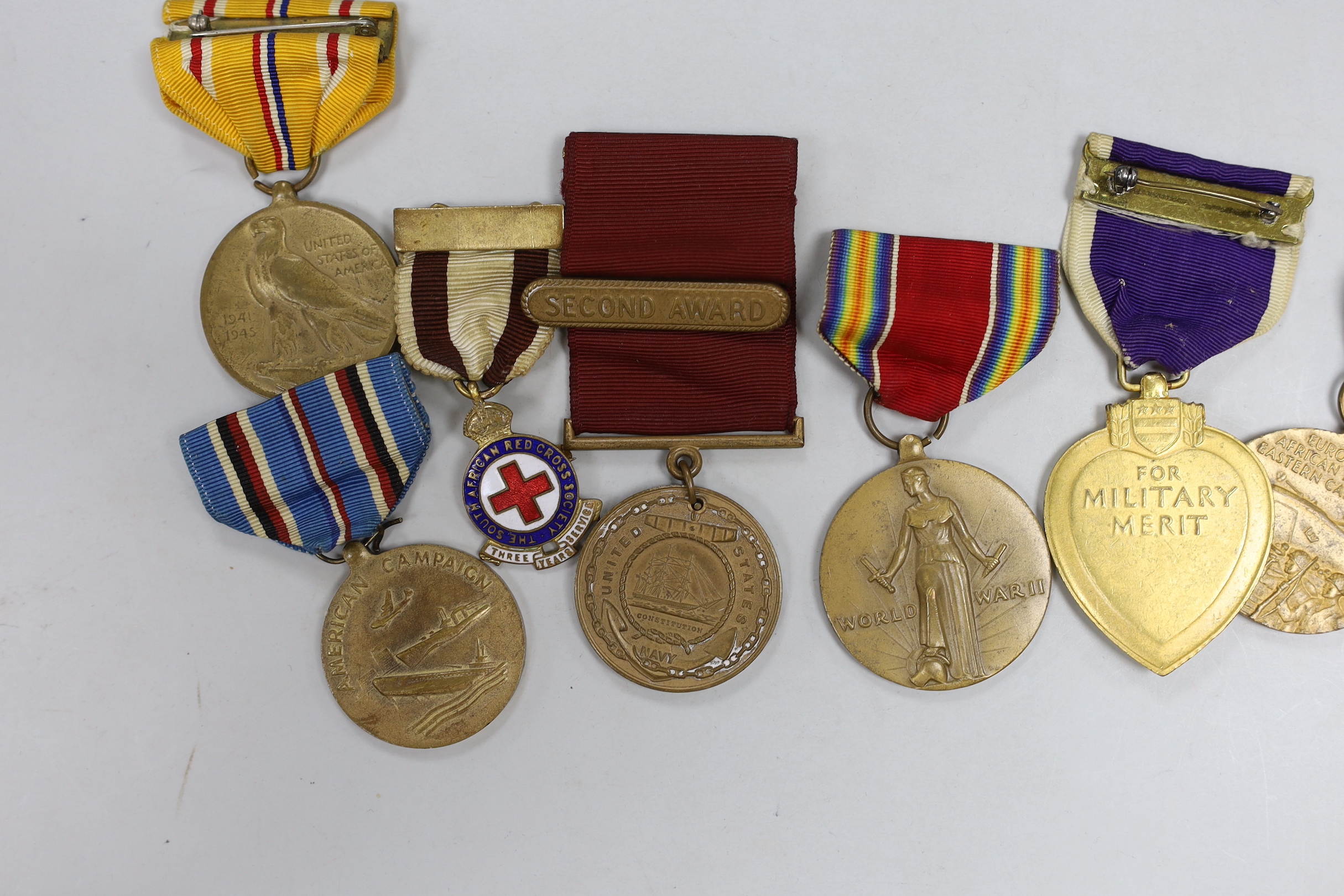 A collection of American WWII medals, including a Purple Heart, unnamed